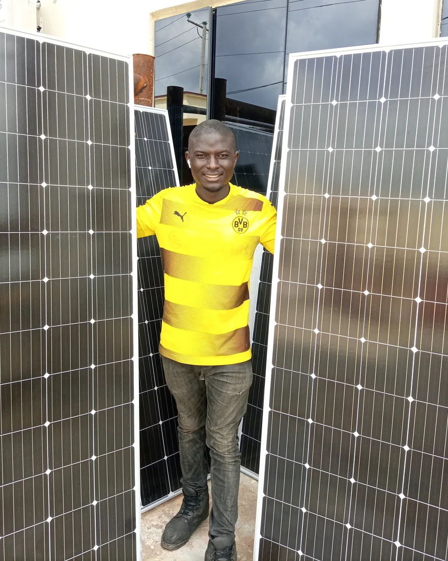 CATPLUG technician with newly delivered solar panels